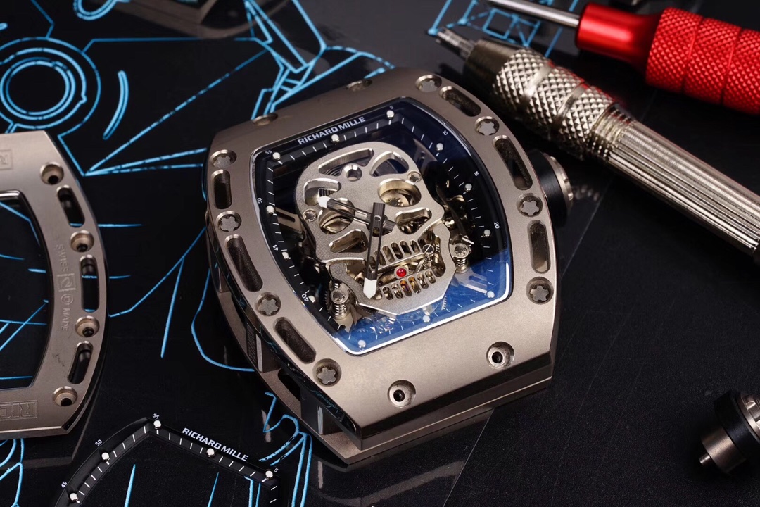 5 - Replica Rolex|Fake Rolex|the best rolex watch factory - Replica Rolex|Fake Rolex|the best rolex watch factory Close-up of a skeleton luxury watch (Richard Mille) with visible gears in a metallic case, surrounded by precision tools on a dark work surface.
