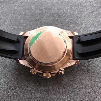 6 - Replica Rolex|Fake Rolex|the best rolex watch factory Back view of a rose-gold watch case with a black rubber strap and green protective sticker on the case back.